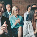 business audience clapping during presentation